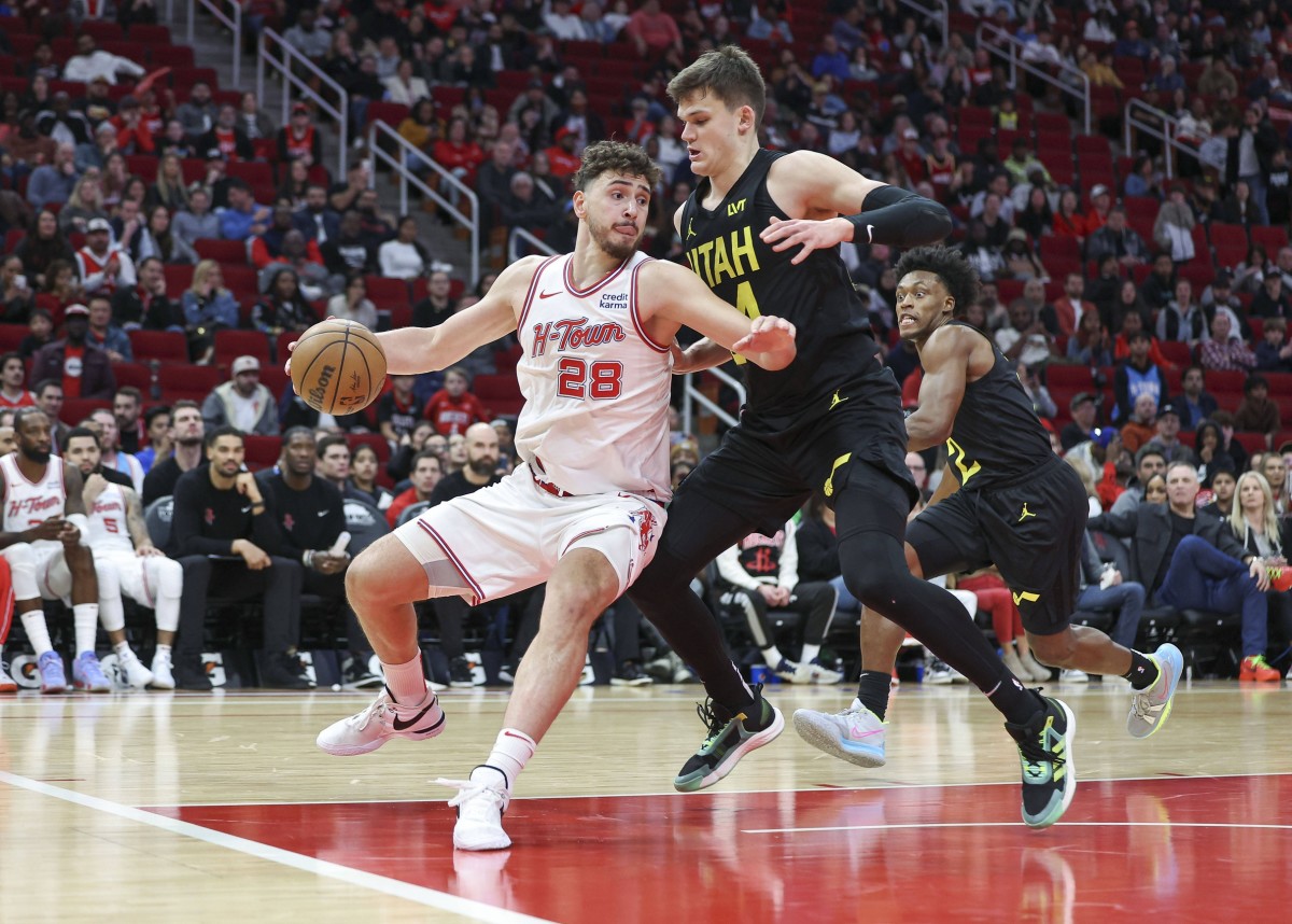 Jan 20, 2024; Houston, Texas, USA; Houston Rockets center Alperen Sengun (28) controls the ball as Utah Jazz center Walker Kessler (24) defends during the fourth quarter at Toyota Center. 